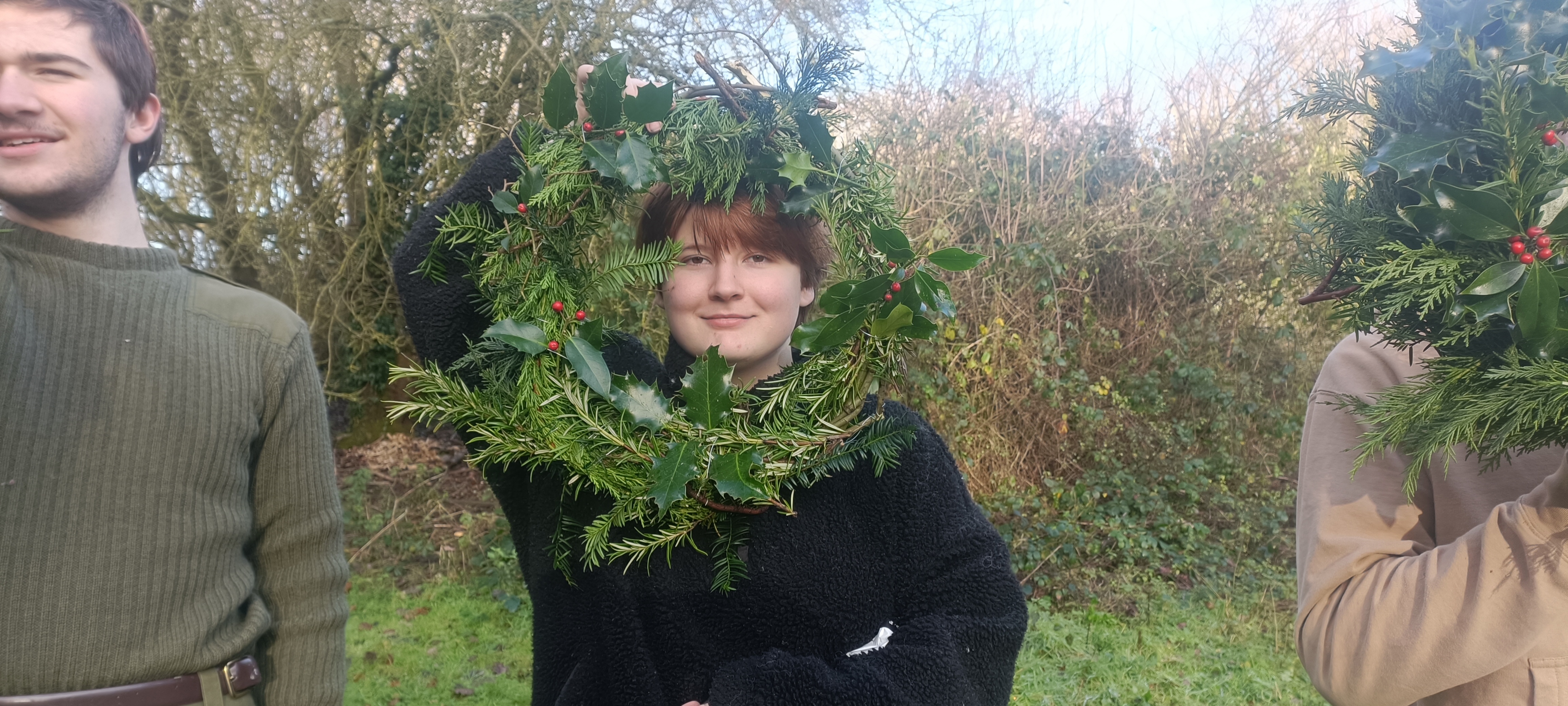 A Young Ranger holding a Christmas Wreath